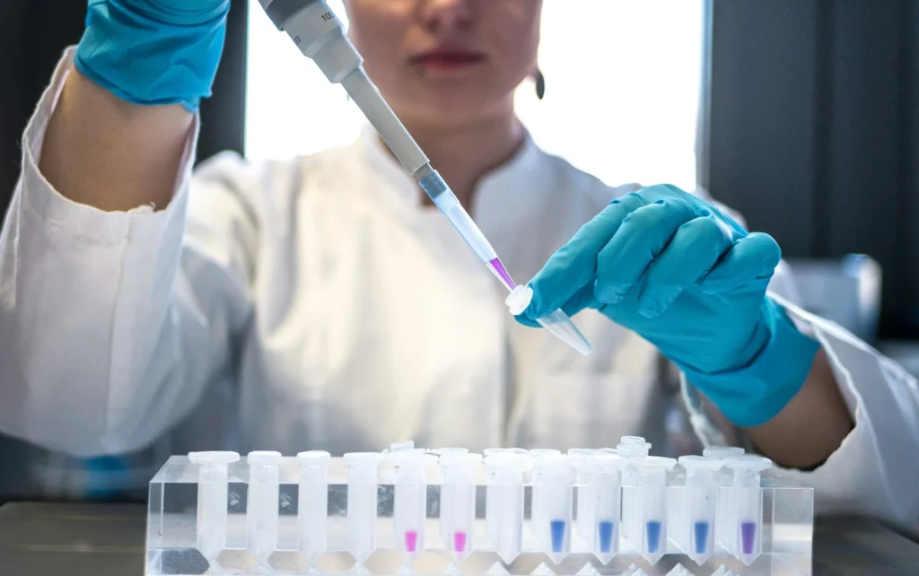 Cercetătoare care lucrează cu o pipetă într-un laborator